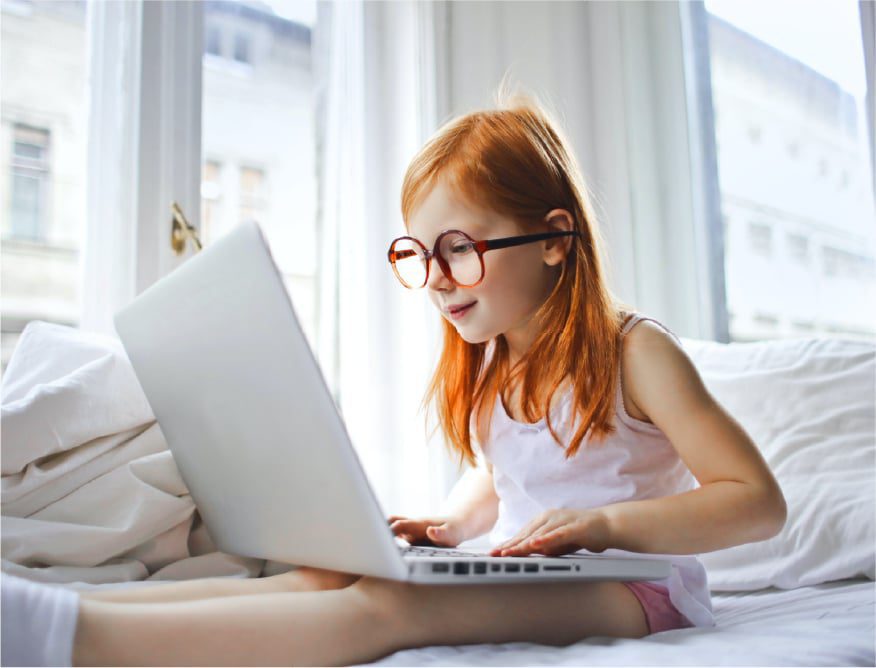 Kid in bed with computer
